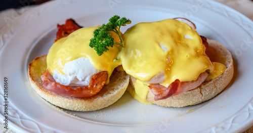 Photos Weekend brunch in Scotland with two eggs benedict on homemade muffuns with roasted bacon and yellow hollandaise sauce