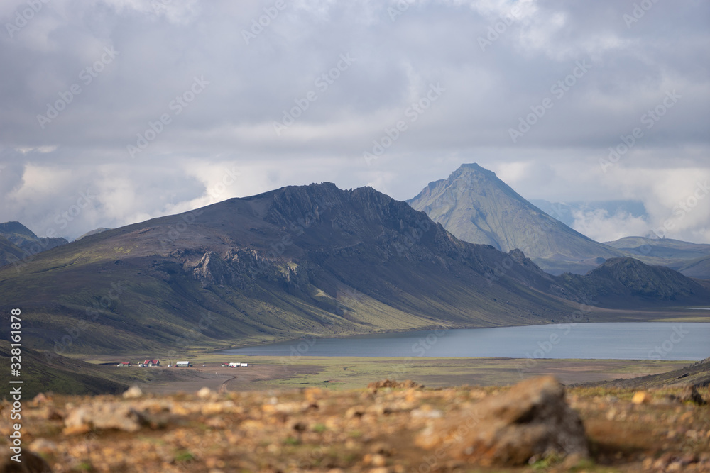 View on Hvanngil mountain hut and camp site with green hills, river stream and lake. Laugavegur hiking trail, Iceland