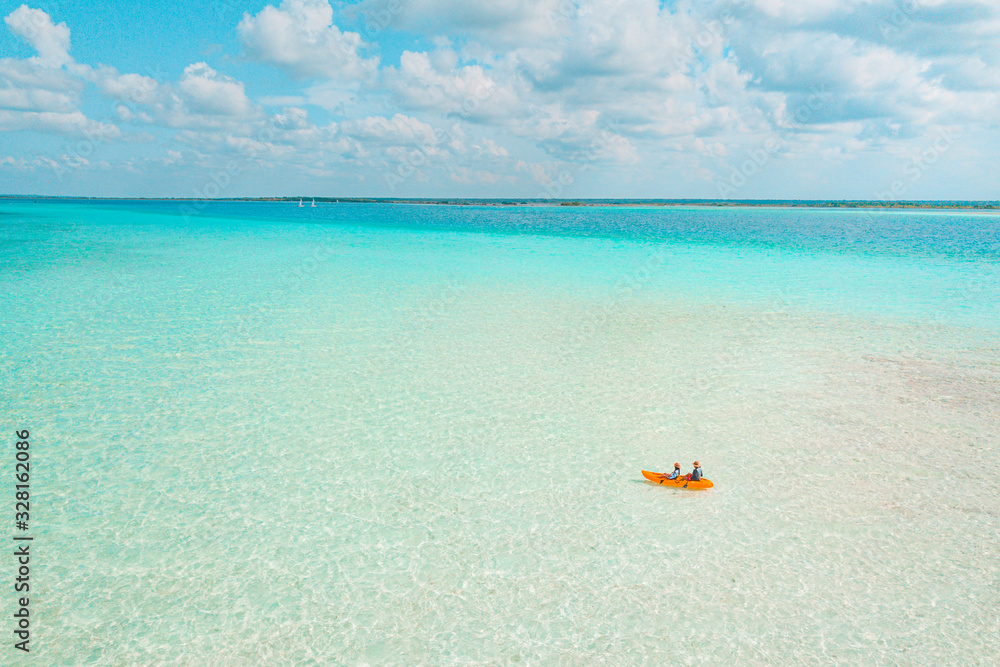 Couple navigating in kayak the Bacalar Lagoon, near Cancun in Riviera Maya, Mexico