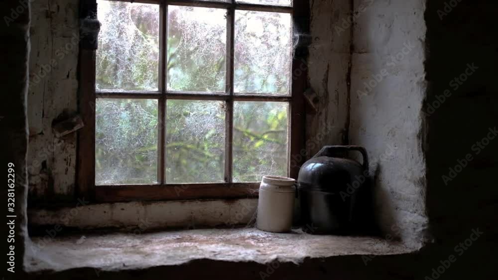 Spooky window covered with webs in an abandoned house. Spooky window covered with webs in an abandoned house.