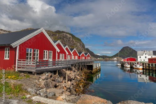typical norwegian village on the fjord. reflection in water