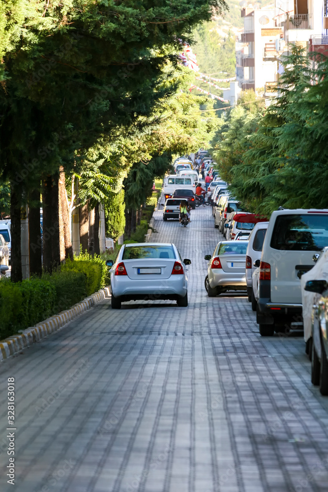 Cars parked on stone-lined road in Antalya