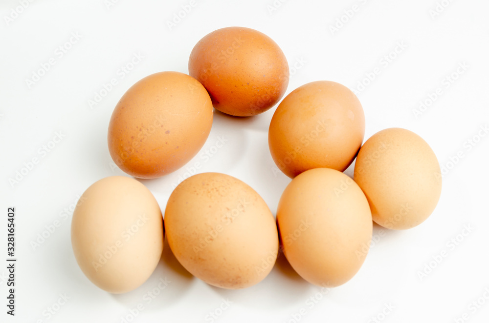 group of fresh brown chicken eggs on a white background group of fresh brown chicken eggs on a white background