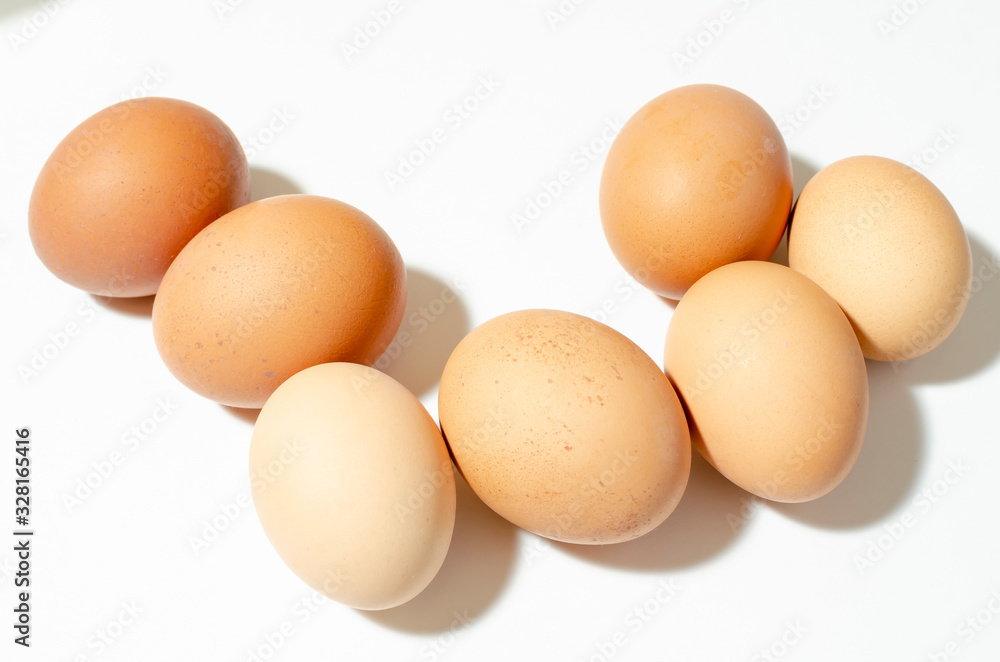 group of fresh brown chicken eggs on a white background group of fresh brown chicken eggs on a white background