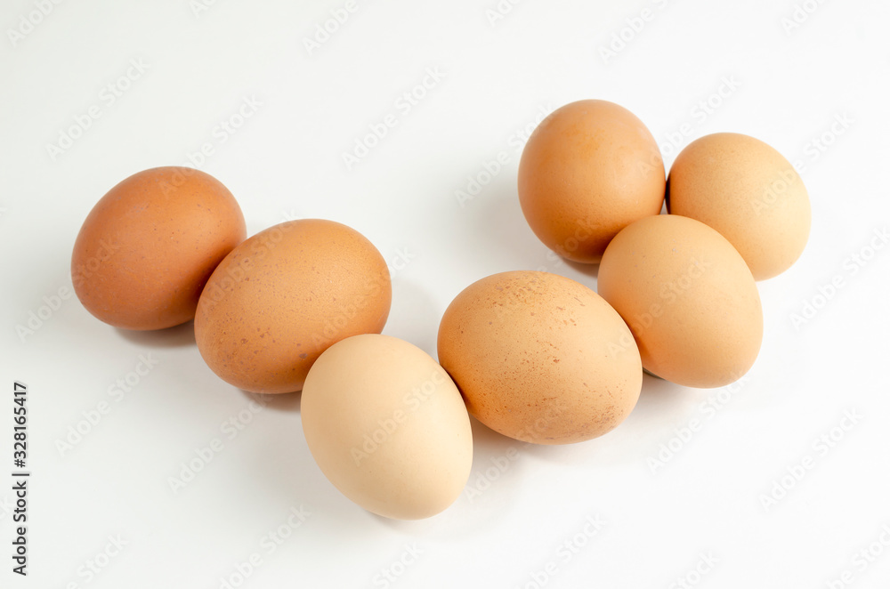 group of fresh brown chicken eggs on a white background group of fresh brown chicken eggs on a white background