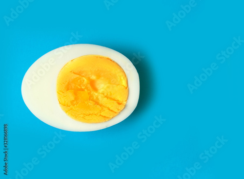 Boiled eggs cuts in half on light background.