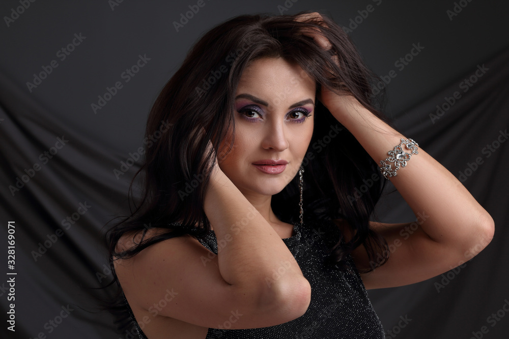 Portrait of a beautiful woman on a gray background