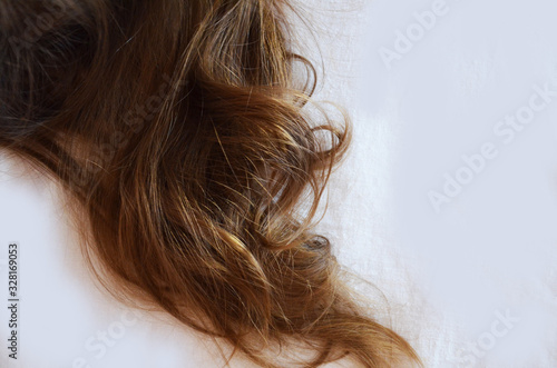 piece of brown hair on white isolated background healthy and shiny