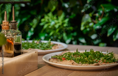 Vegan pizza with fresh arugula