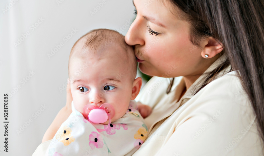 family mother playing with newborn baby on the baby room family mother playing with newborn baby on the baby room