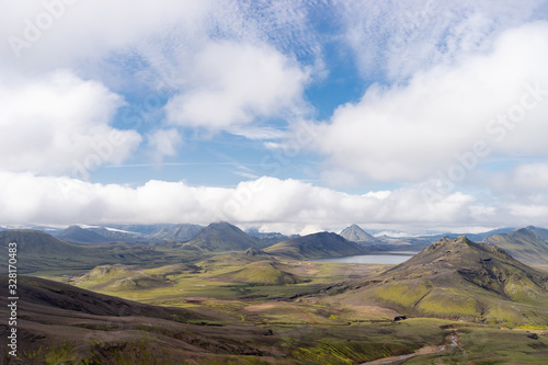 View mountain valley with green hills, river stream and lake. Laugavegur hiking trail, Iceland