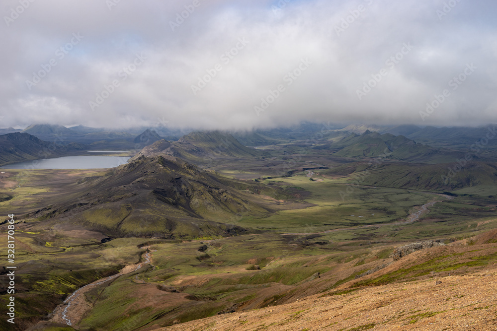 View mountain valley with green hills, river stream and lake. Laugavegur hiking trail, Iceland