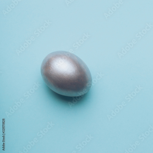 Silver easter egg on a blue background.