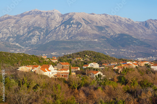 Beautiful winter Mediterranean landscape. Village in mountains. Montenegro, historical region of Krtoli on Lustica peninsula against Lovcen mountain. View of Bogisici village
