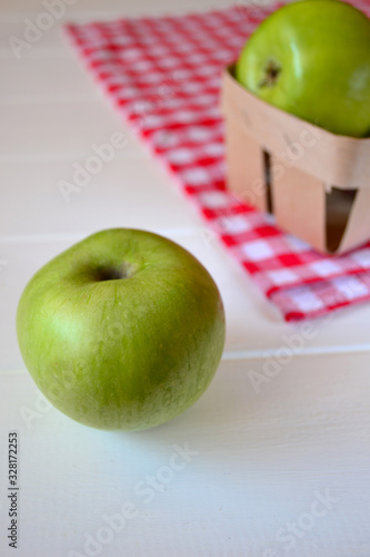 Green apples on a white wooden background