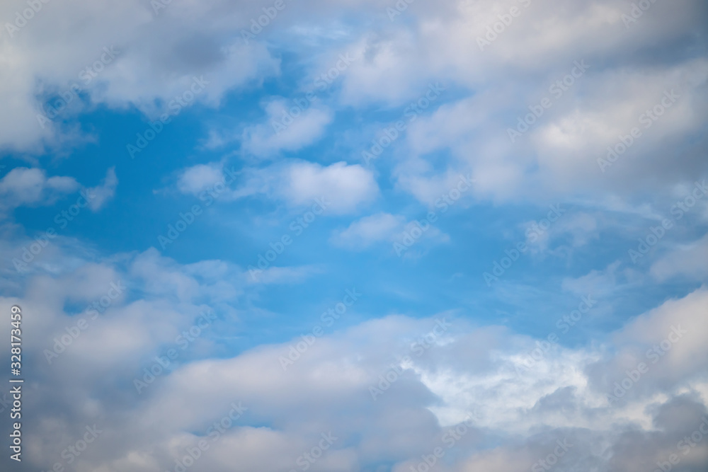 Fototapeta premium Błękitne niebo z białymi fantazyjnymi stosami chmur.
