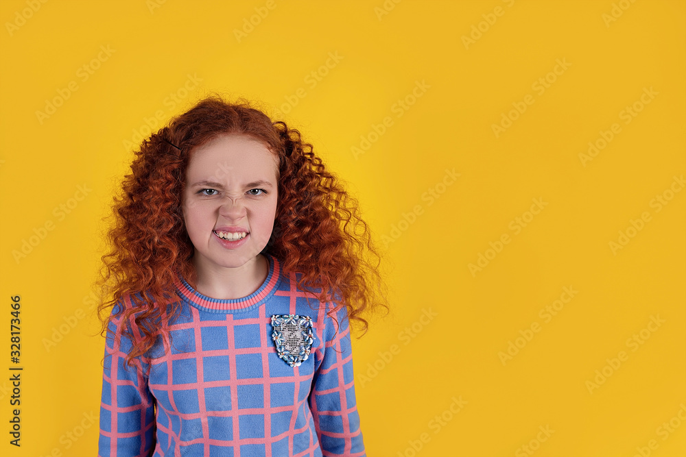 Beautiful red-haired girl on a yellow background Beautiful red-haired girl on a yellow background