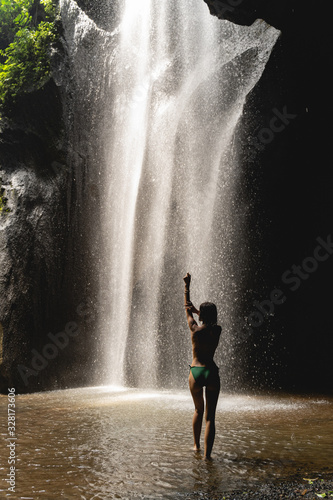 Fototapeta Naklejka Na Ścianę i Meble -  Attractive female person enjoying her washing in cave