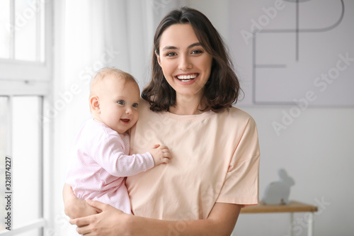 Cute baby with mother at home