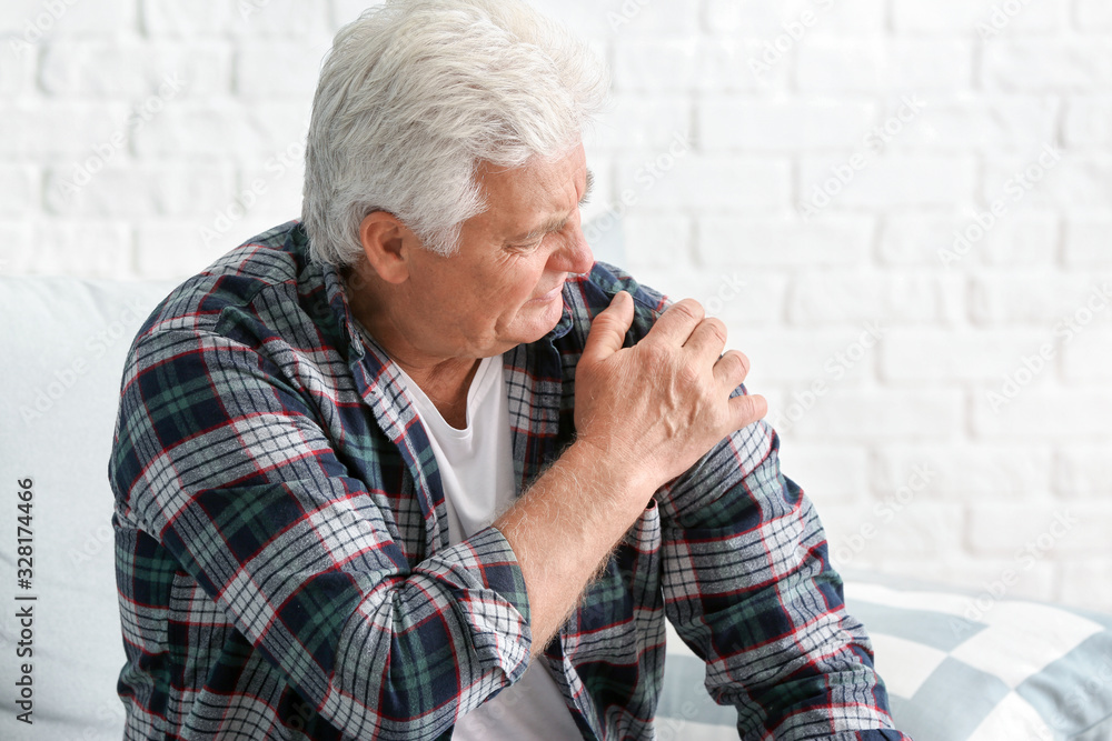 Senior man suffering from Parkinson syndrome at home Senior man suffering from Parkinson syndrome at home
