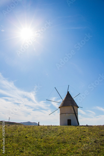 backlit windmill image, windmill traditional in Spain, Pozo de los Frailes, province of Almeria, windmill under blue sky, traditional white windmill