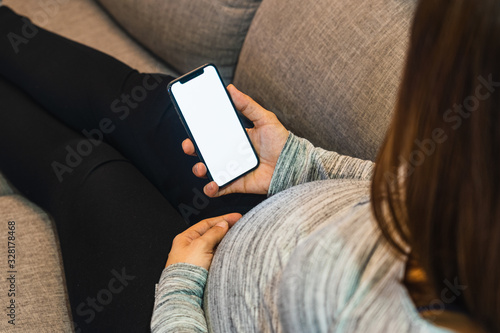 Pregnant woman using a phone