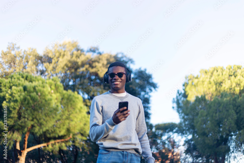 Afro young man using mobile phone. Afro young man using mobile phone.