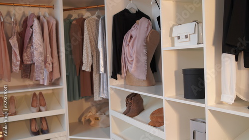 Close-up of interior design wardrobe. Modern light women's dressing room with various things.