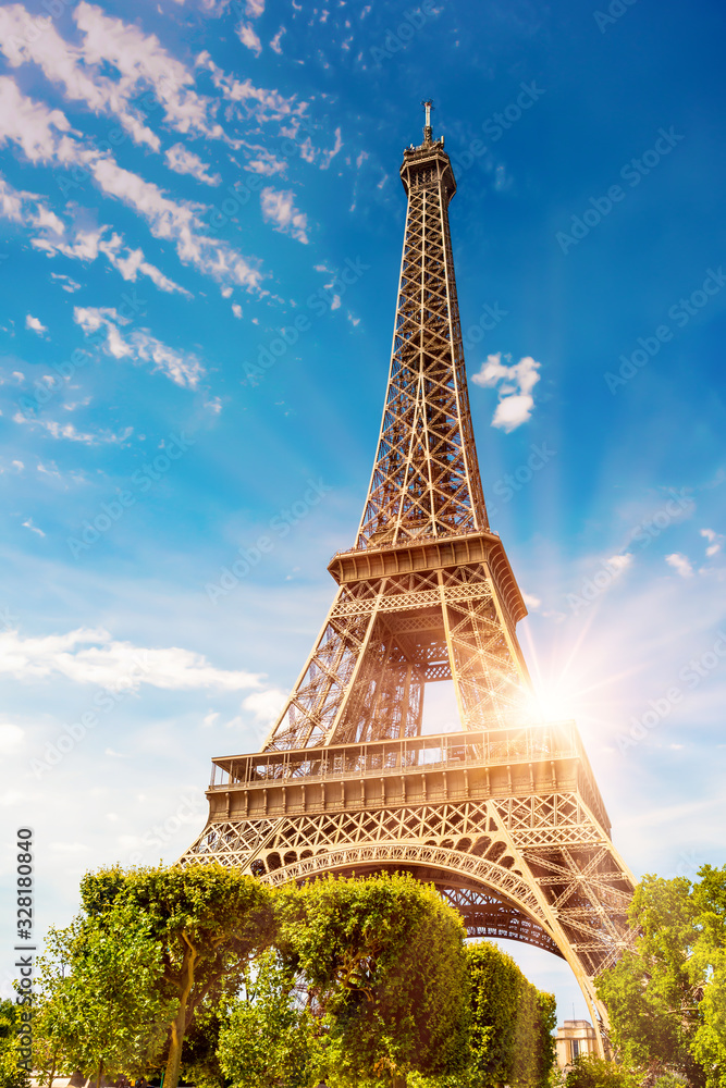 The Eiffel Tower in Paris on a beautiful sunny summer day at sunset ...