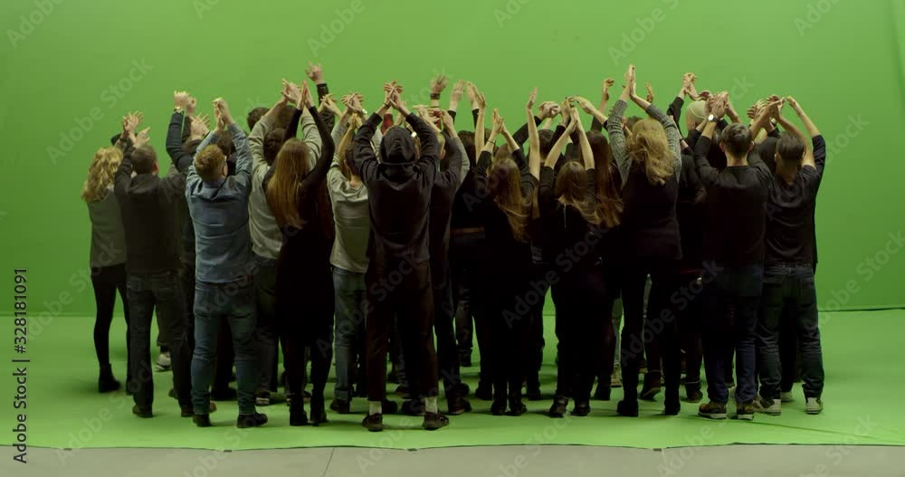 GREEN SCREEN CHROMA KEY Model released, back view of huge crowd clapping and cheering at a concert or a show. Shot on RED Helium 8K in RAW