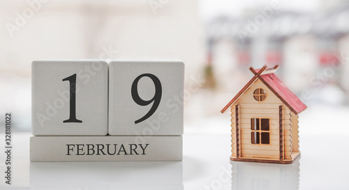 February calendar and toy home. Day 19 of month. Card message for print or remember