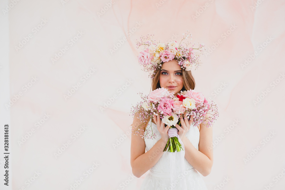 Portrait of beautiful bride with flower wreath on her head and bridal bouquet