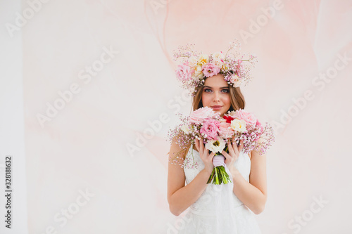 Obraz na płótnie Portrait of beautiful bride with flower wreath on her head and bridal bouquet