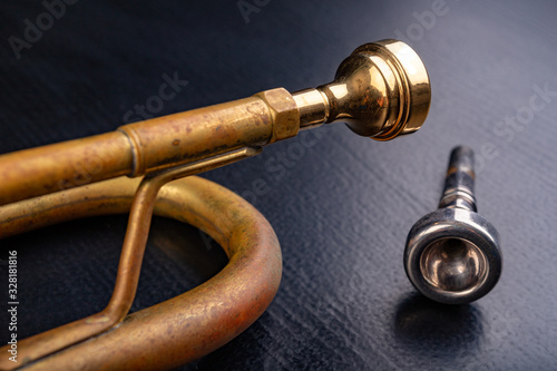 Mouthpiece of an old trumpet covered with patina. Musical instrument shown in magnification.