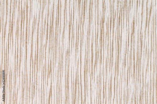 Texture with spotty coarse fabric of cream and beige. Background.