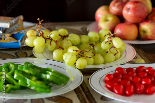 Plates with fruits and vegetables as alternative healthy snacks at a party