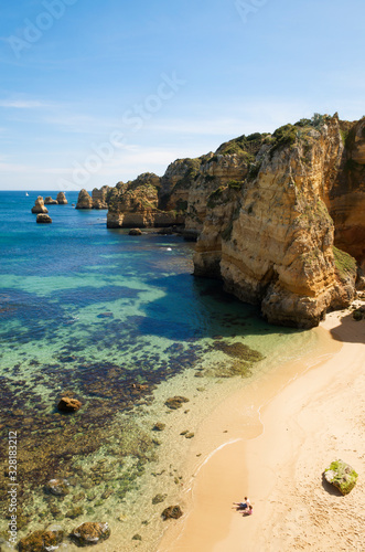 Bright sunny view of the rugged Atlantic coastline of the Algarve at Dona Ana beach near Lagos, Portugal