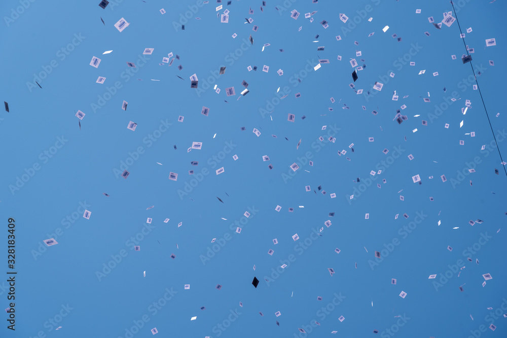 Buenos Aires, Argentina; December 10, 2019: Panflets falling from a roof of a building in the assumption of Alberto Fernandez as president Buenos Aires, Argentina; December 10, 2019: Panflets falling from a roof of a building in the assumption of Alberto Fernandez as president