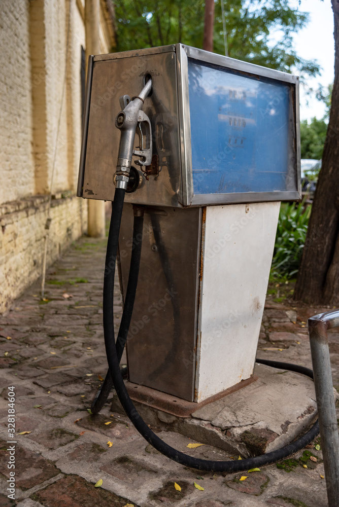 Old dirty gas station, rusted, old and abandoned gas dispenser. The end of fossil energy