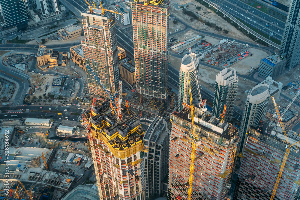 Modern construction sites of high rise building in Dubai, view from above.