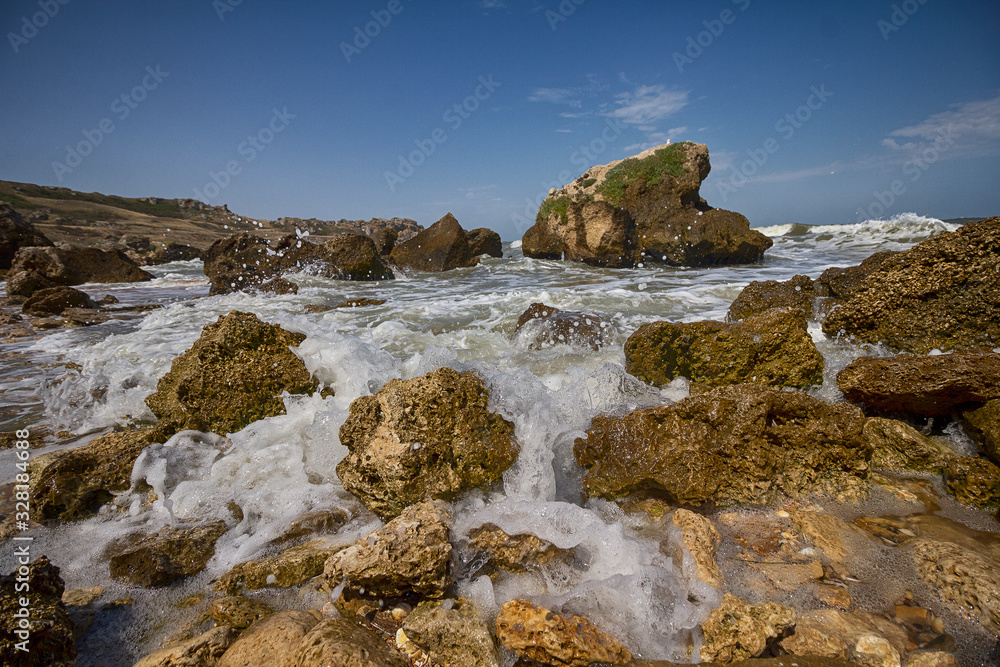 Stones and waves on the beach closeup. Crimea