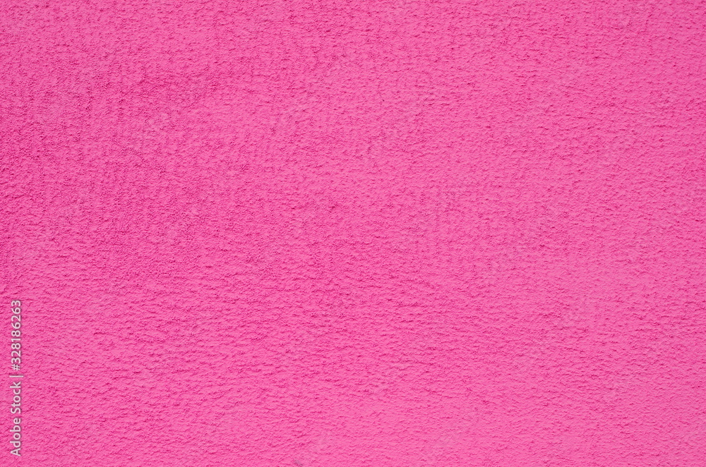 Background of a pink stucco coated and painted exterior, rough cast of cement and concrete wall texture, decorative coating Background of a pink stucco coated and painted exterior, rough cast of cement and concrete wall texture, decorative coating