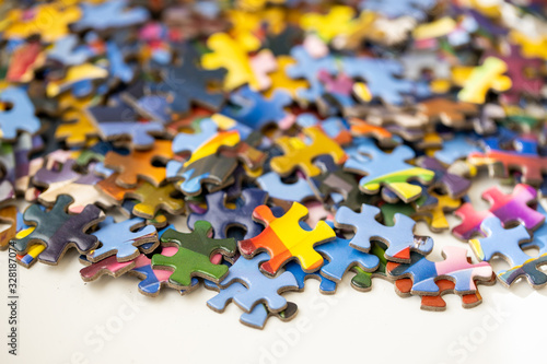 Pile of colourful jigsaw puzzle pieces on a table