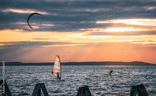 Photography Kite Surfers and Wind Surfer at Neusiedl Lake in Podersdorf, Austria at Sunset