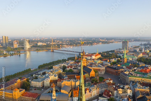 Aerial view photo from flying drone panoramic to Close-up golden cock of St. Peter's Basilica tower, Riga, Latvia