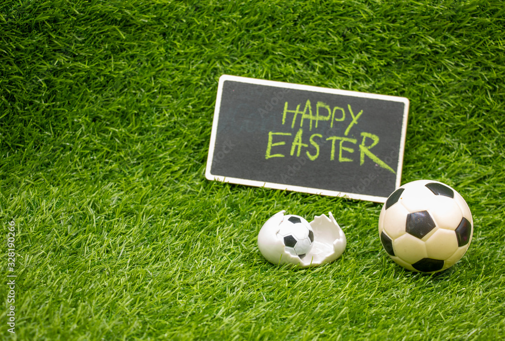 Naklejka premium Soccer Easter with football and egg shell on green grass