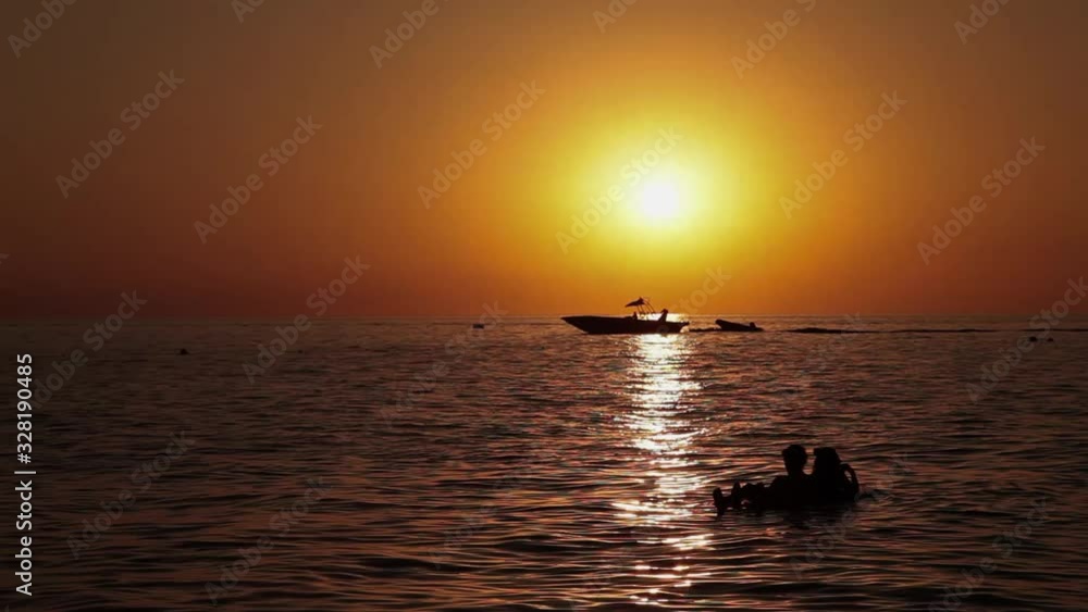 Boat is sailing on the sunset on the sea Boat is sailing on the sunset on the sea