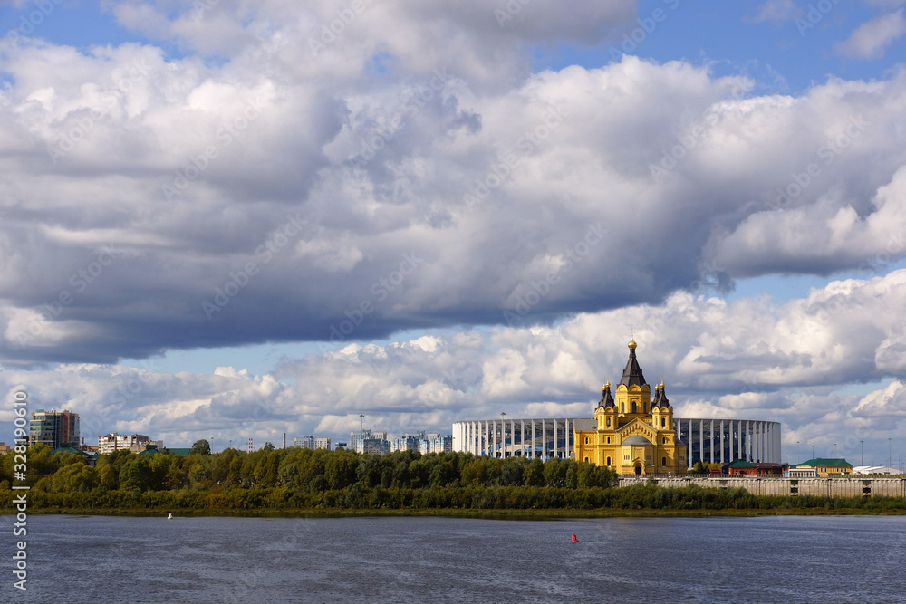 Nizhny Novgorod, Russia - September 15, 2019. View of the Alexander Nevsky Cathedral and the new stadium from the side of the Nizhny Novgorod Kremlin. Landscape with thunderclouds