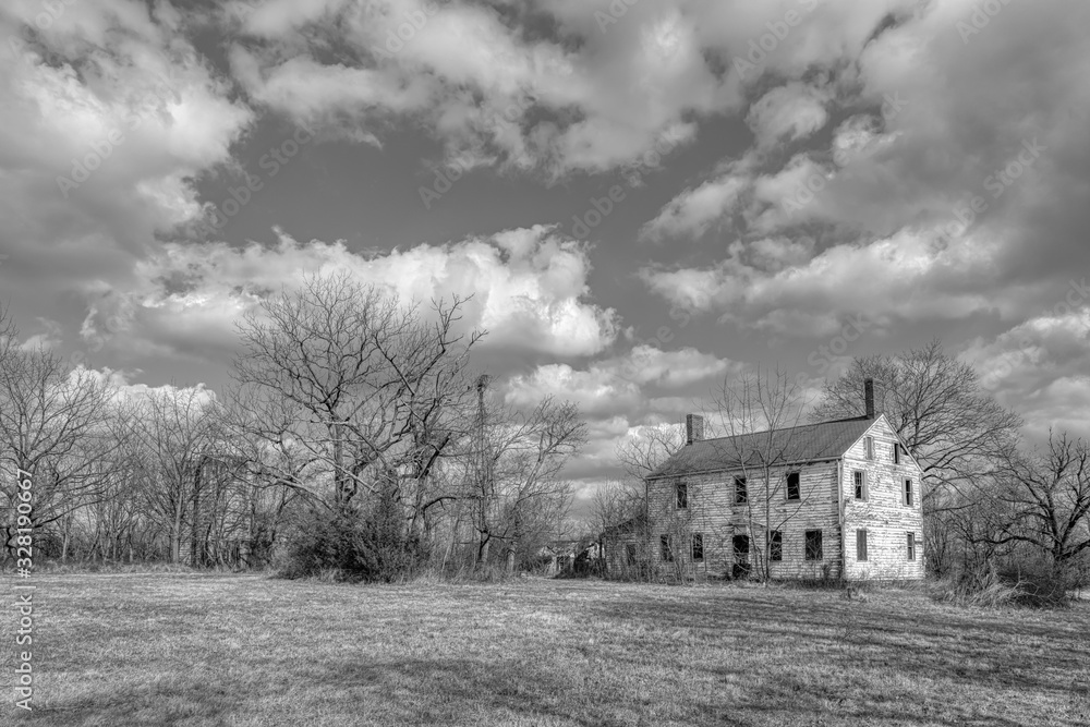 Black and white photograph of an abandoned haunted       farm house of Six Mile Run, New Jersey.