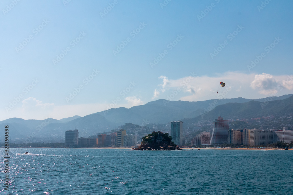 Naklejka premium view of the city, sea and blue sky, parachute tourist.
